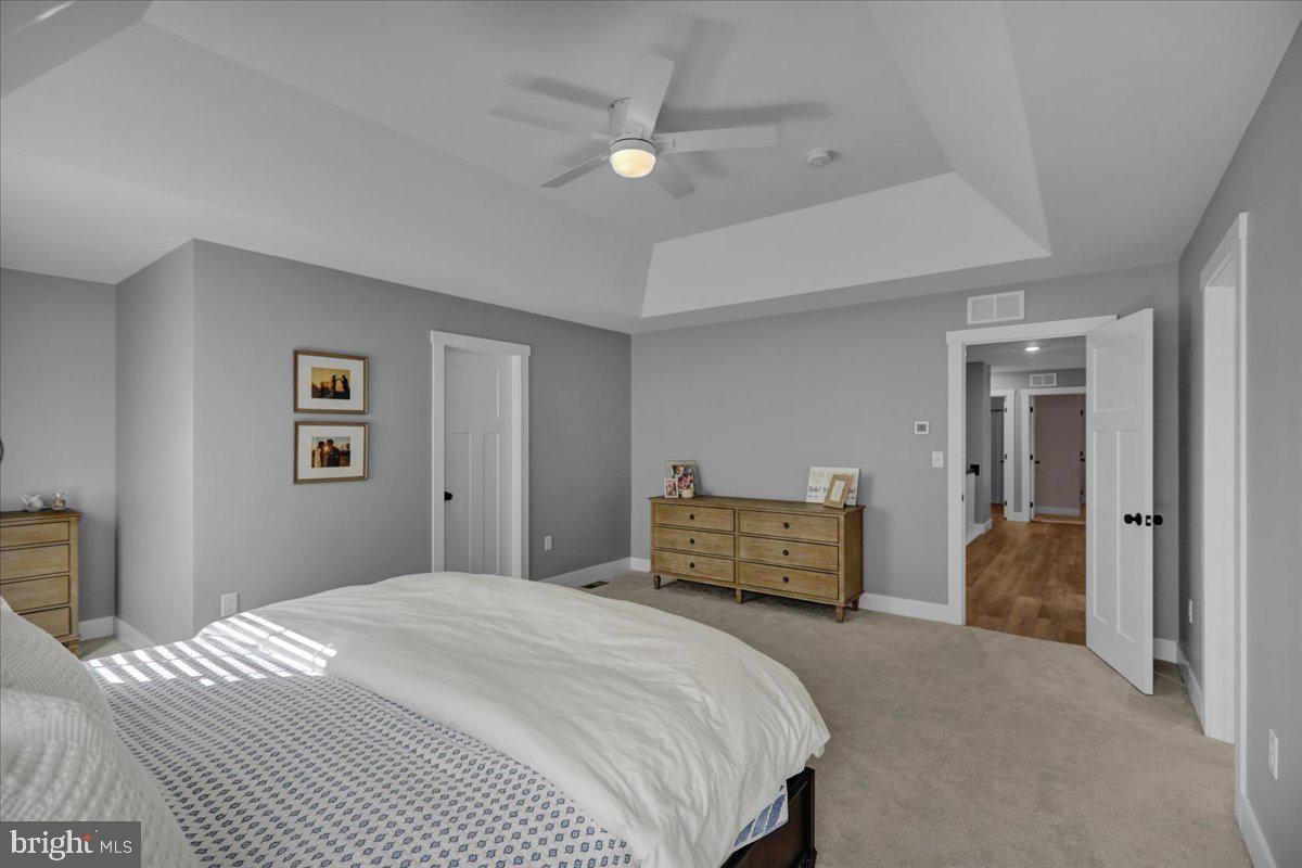 1057 Ryebrook Road Reading, PA 19608 - Photo 23 of 49 a bedroom with a large bed and a chandelier