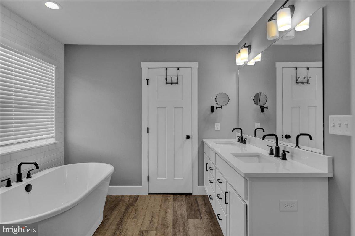 1057 Ryebrook Road Reading, PA 19608 - Photo 26 of 49 a bathroom with a double vanity sink a mirror and a bathtub