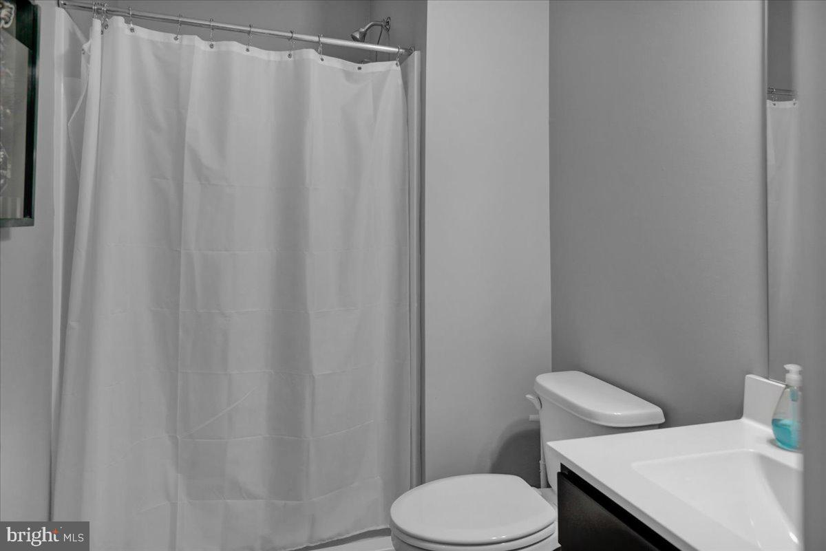 1057 Ryebrook Road Reading, PA 19608 - Photo 40 of 49 a white toilet sitting next to a shower curtain