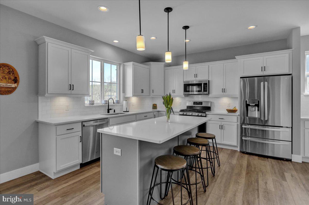 1057 Ryebrook Road Reading, PA 19608 - Photo 10 of 49 a kitchen with kitchen island granite countertop a sink a center island and stainless steel appliances