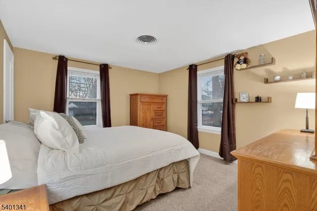 a bedroom with a bed and a refrigerator