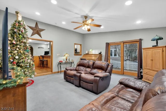 a living room with furniture a chandelier and a window