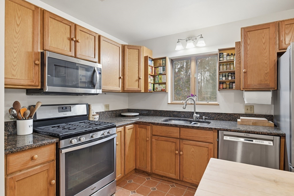 359 Montague Road Shutesbury, MA 01072 - Photo 11 of 38 a kitchen with stainless steel appliances granite countertop a sink stove microwave and cabinets