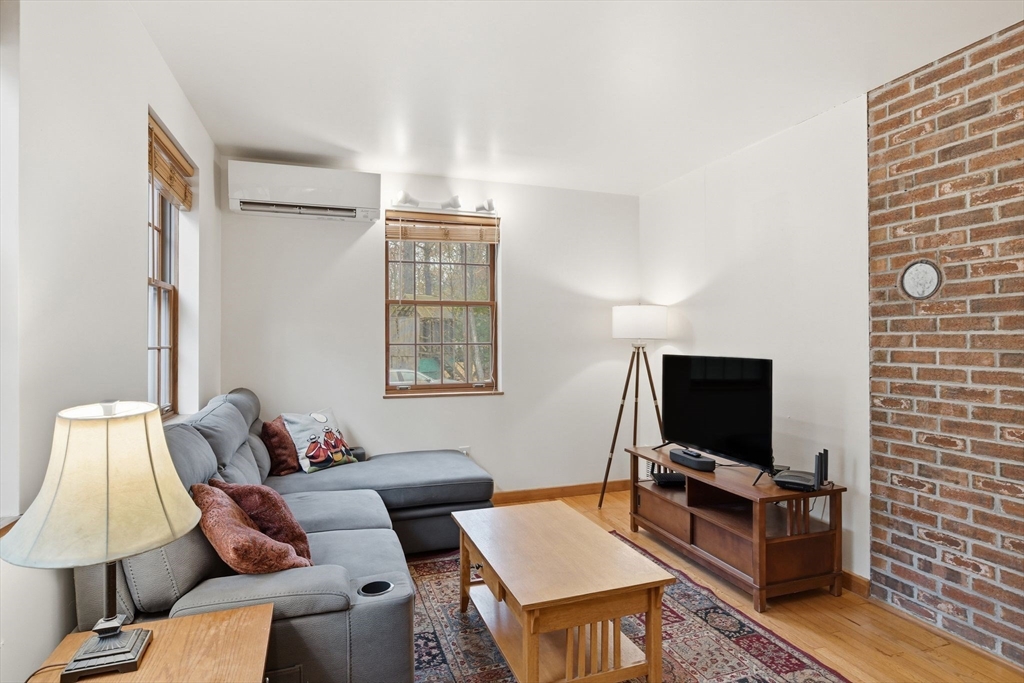359 Montague Road Shutesbury, MA 01072 - Photo 13 of 38 a living room with furniture and a flat screen tv