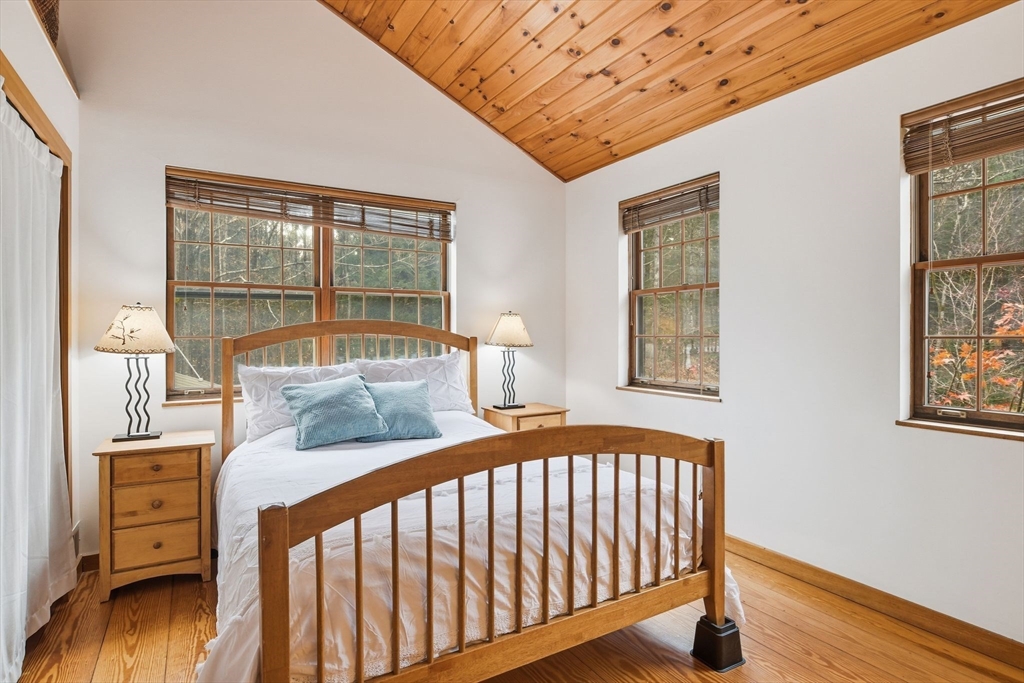 359 Montague Road Shutesbury, MA 01072 - Photo 16 of 38 a bedroom with a bed and wooden floor