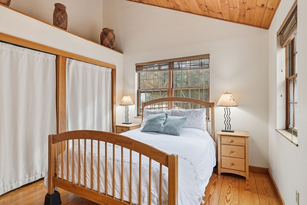 359 Montague Road Shutesbury, MA 01072 - Photo 17 of 38 a bedroom with a bed and wooden floor