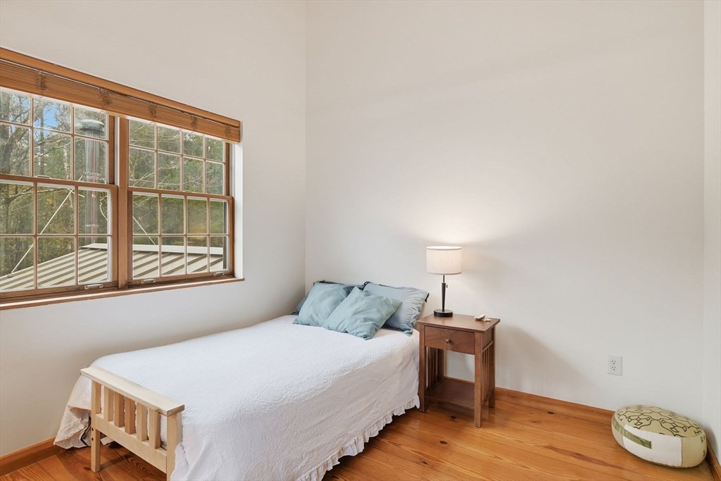 359 Montague Road Shutesbury, MA 01072 - Photo 18 of 38 a bedroom with a bed and a window