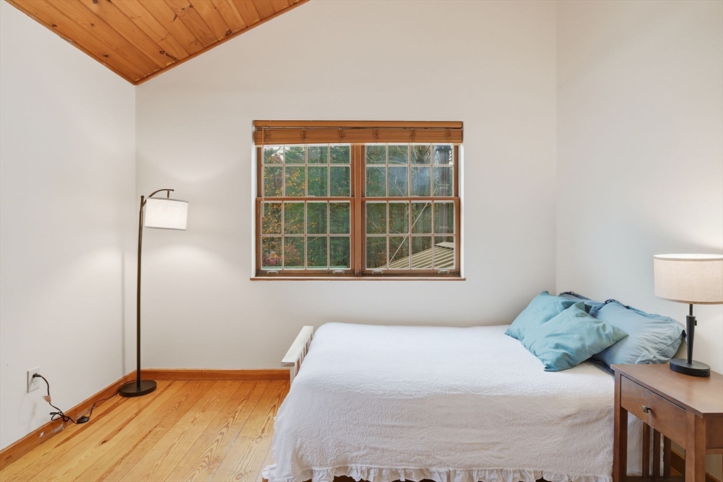 359 Montague Road Shutesbury, MA 01072 - Photo 20 of 38 a bedroom with a bed and a window