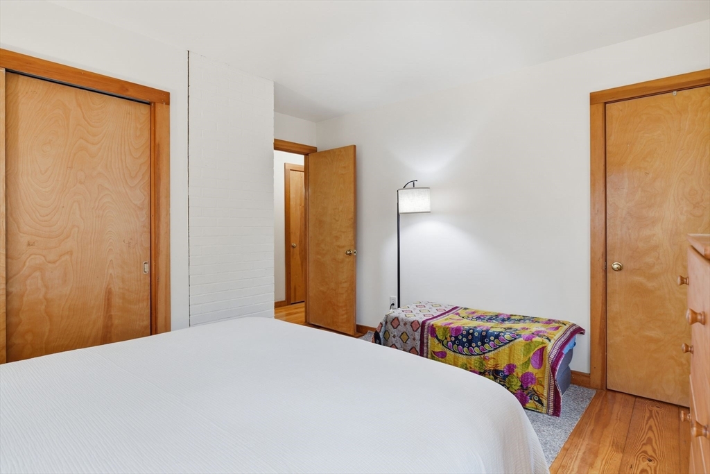 359 Montague Road Shutesbury, MA 01072 - Photo 26 of 38 a bedroom with a bed and wooden floor