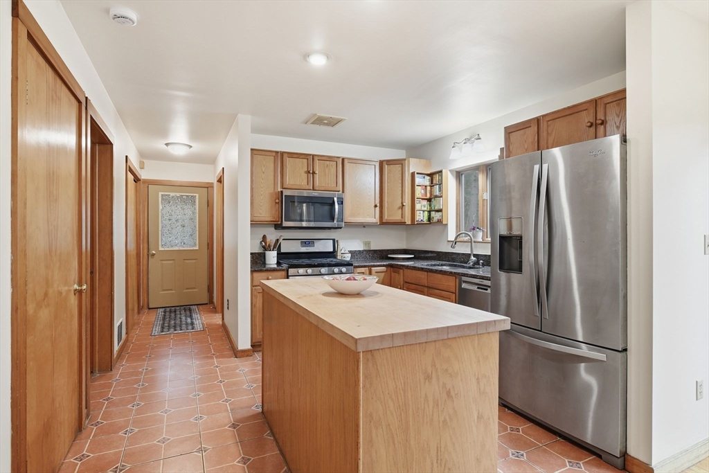 359 Montague Road Shutesbury, MA 01072 - Photo 9 of 38 a kitchen with stainless steel appliances a refrigerator stove microwave and sink