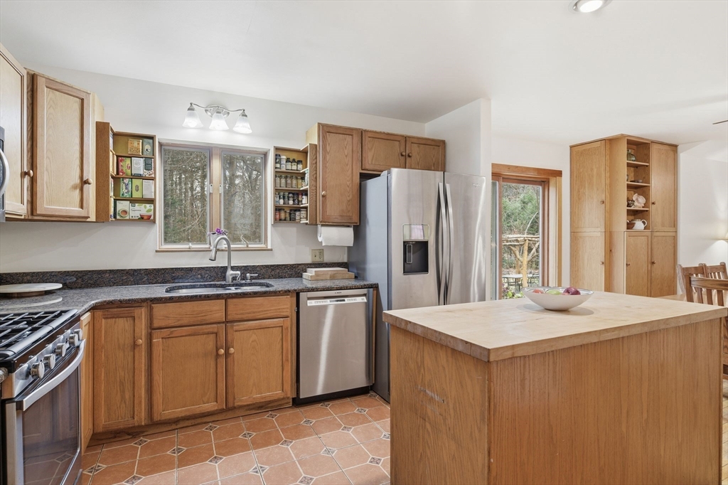 359 Montague Road Shutesbury, MA 01072 - Photo 10 of 38 a kitchen with stainless steel appliances a sink and a refrigerator