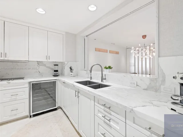 a kitchen with cabinets appliances and a sink