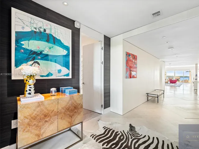 a living room with furniture and wall paintings