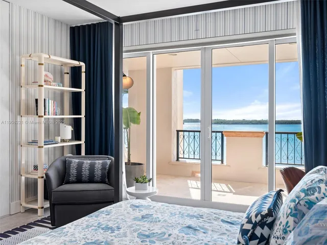 a bedroom with furniture and large window