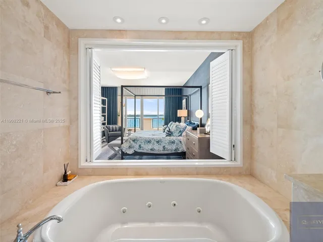 a bathroom with a bathtub and a window