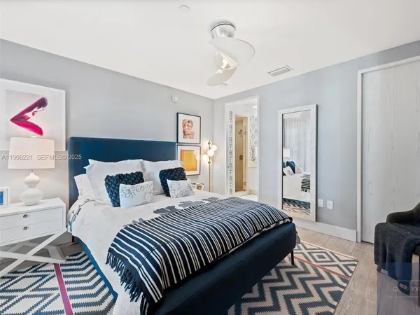 a bedroom with double bed and a dresser