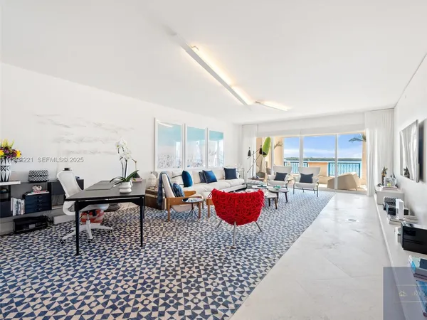 a living room with furniture a rug and a table