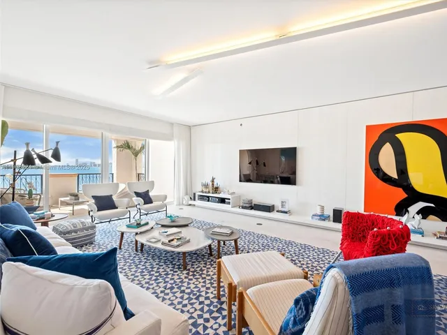 a living room with furniture a rug and a window