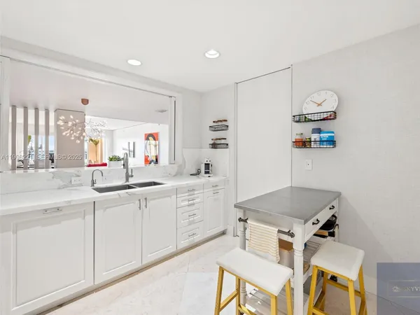 a kitchen with a sink cabinets and window