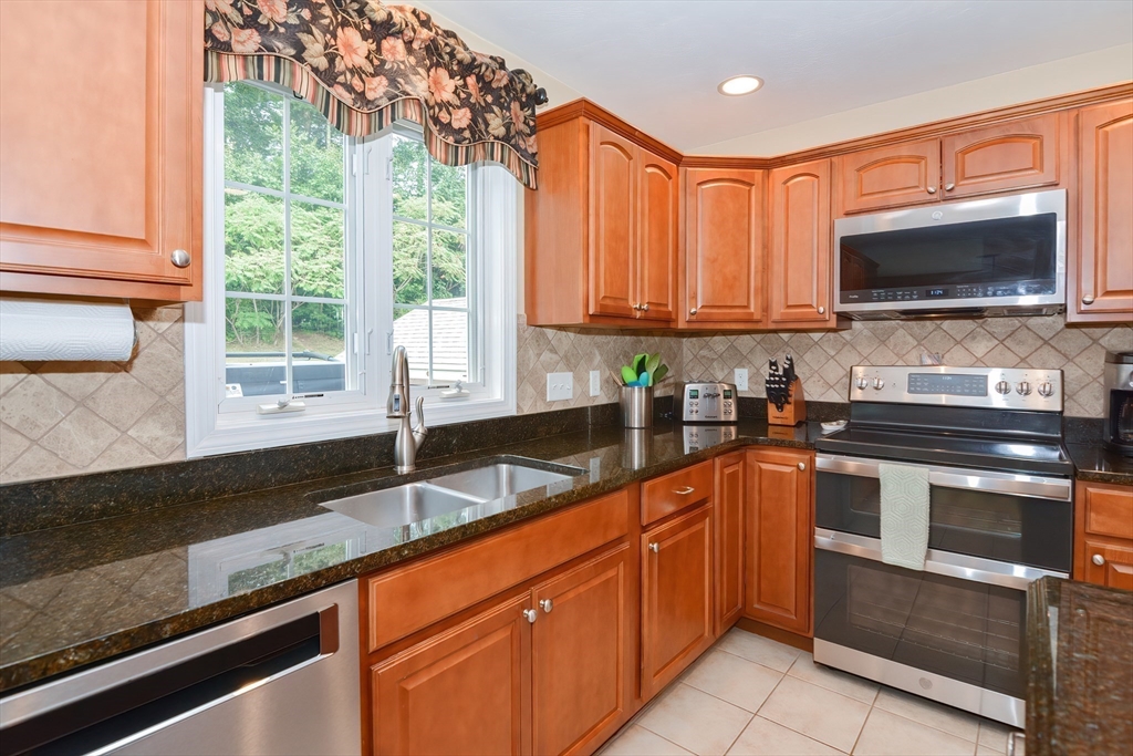 14 Tannery Road Sturbridge, MA 01518 - Photo 6 of 41 a kitchen with granite countertop a sink a counter top space appliances and cabinets