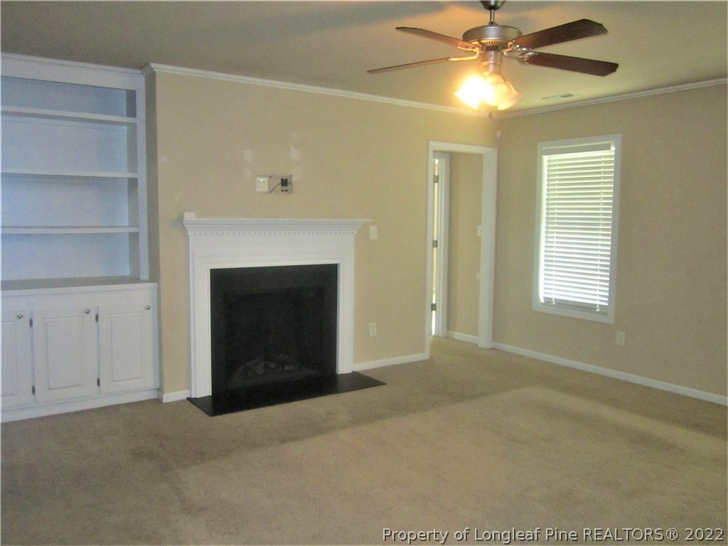 558 Cape Fear Road Raeford, NC 28376 - Photo 4 of 10 a view of an empty room with a fireplace and a window