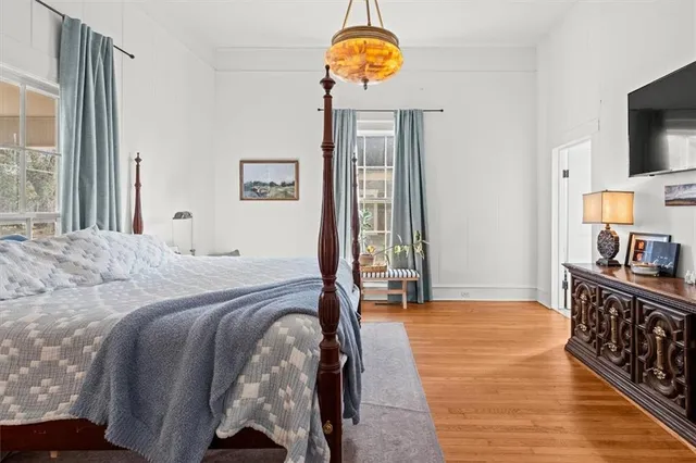a bedroom with a bed and a flat tv screen on a dresser