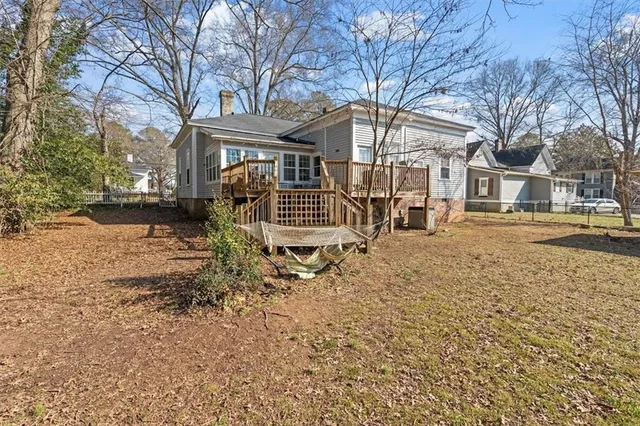 a view of a house with a yard covered in snow