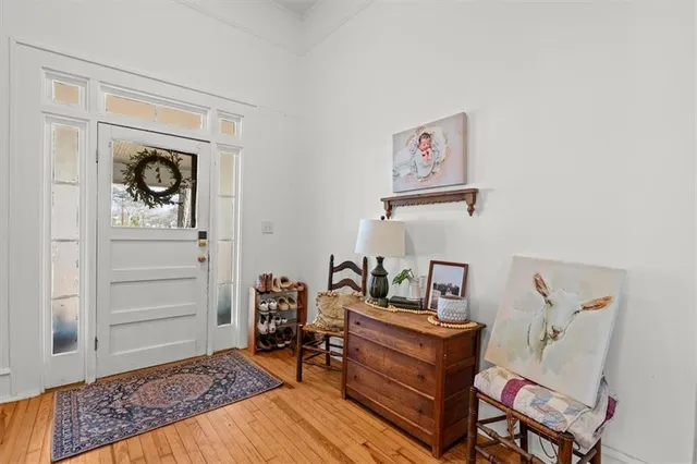 a living room with furniture and painting on the wall