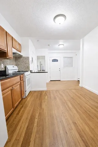 a view of a kitchen with wooden floor