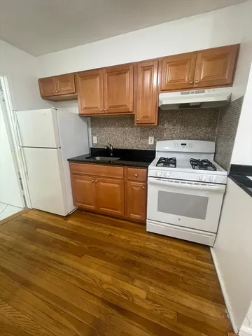 a kitchen with granite countertop a stove and a cabinets
