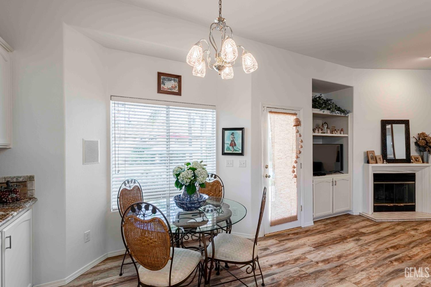 Undisclosed Address Bakersfield, CA 93312 - Photo 12 of 43 a view of a dining room with furniture window and wooden floor