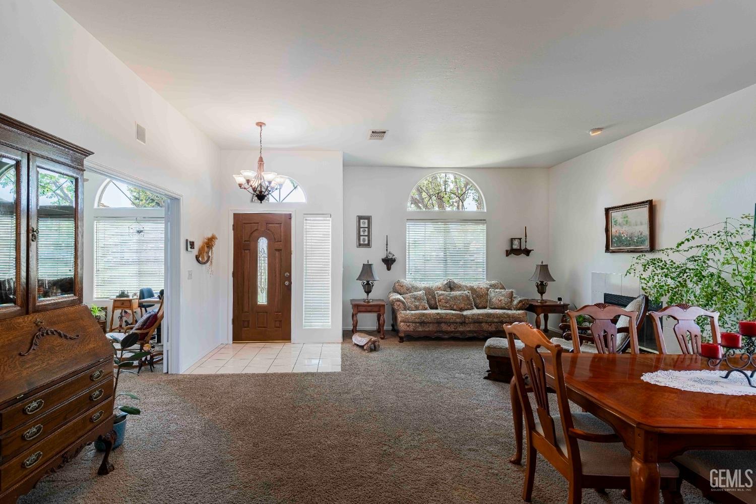 Undisclosed Address Bakersfield, CA 93312 - Photo 17 of 43 a living room with furniture and a chandelier