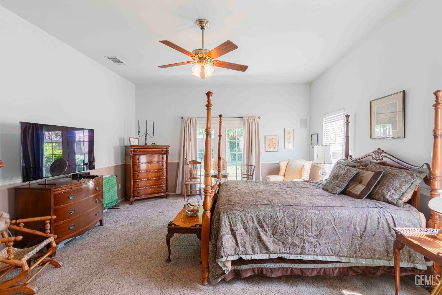 Undisclosed Address Bakersfield, CA 93312 - Photo 25 of 43 a bedroom with a bed and a chandelier