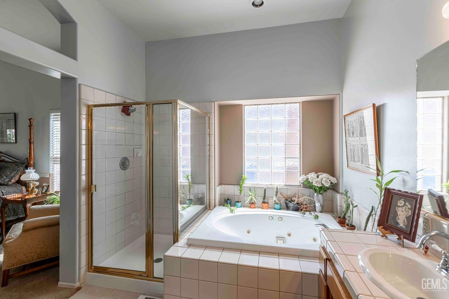 Undisclosed Address Bakersfield, CA 93312 - Photo 27 of 43 a bathroom with a tub sink and mirror