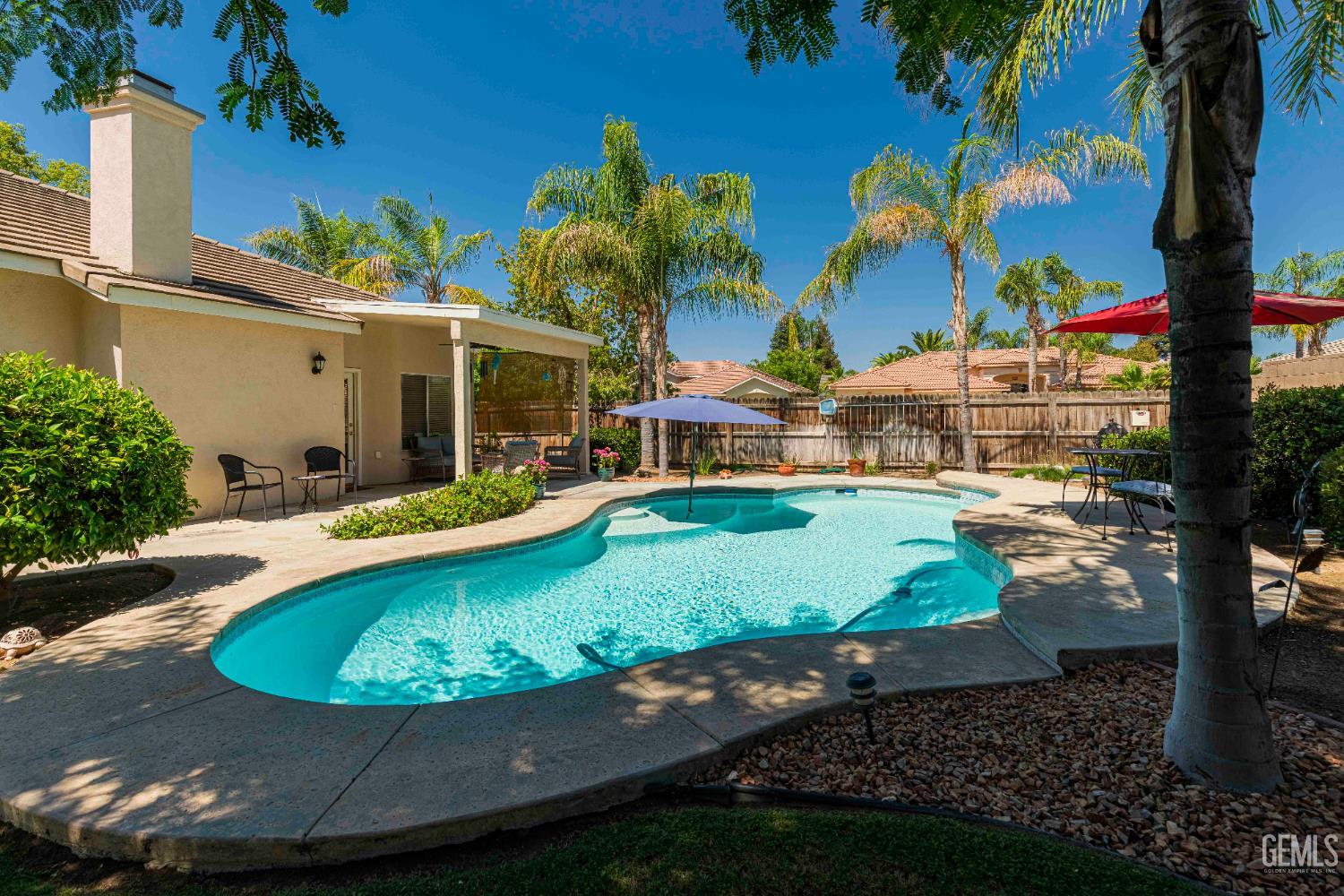 Undisclosed Address Bakersfield, CA 93312 - Photo 35 of 43 a view of a swimming pool with a yard