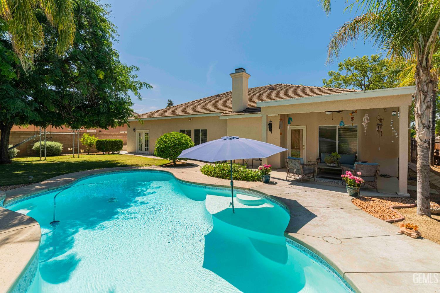 Undisclosed Address Bakersfield, CA 93312 - Photo 38 of 43 a swimming pool with outdoor seating yard and patio