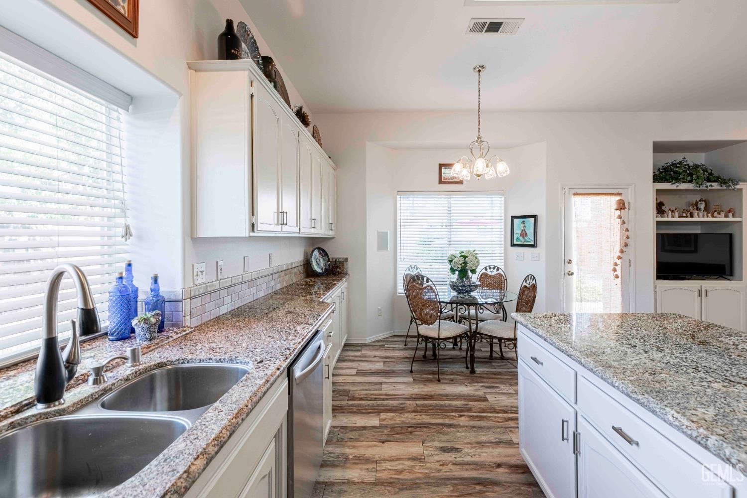 Undisclosed Address Bakersfield, CA 93312 - Photo 9 of 43 a kitchen with granite countertop a sink stove and refrigerator