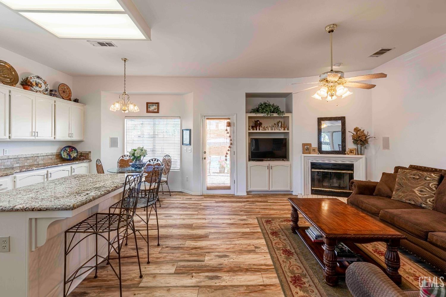 Undisclosed Address Bakersfield, CA 93312 - Photo 10 of 43 a view of a livingroom with furniture and a fireplace