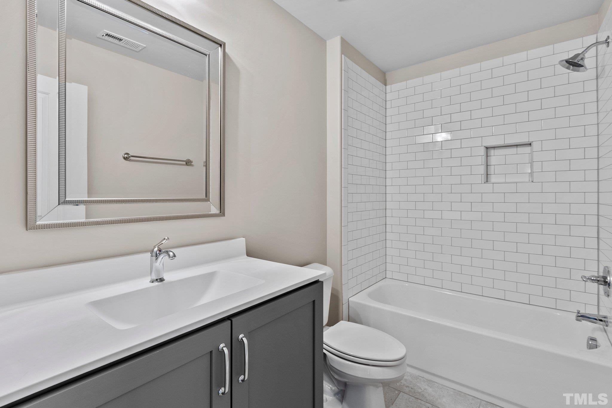 13304 Cleveland Road Garner, NC 27529 - Photo 53 of 61 a bathroom with a sink a toilet and shower