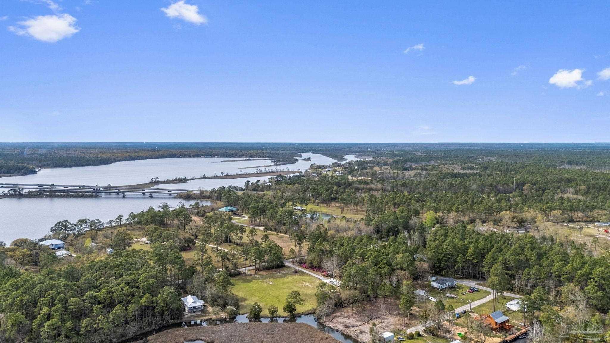 7524 Petersen Point Road Milton, FL 32583 - Photo 21 of 26 an aerial view of a house with a yard and lake view