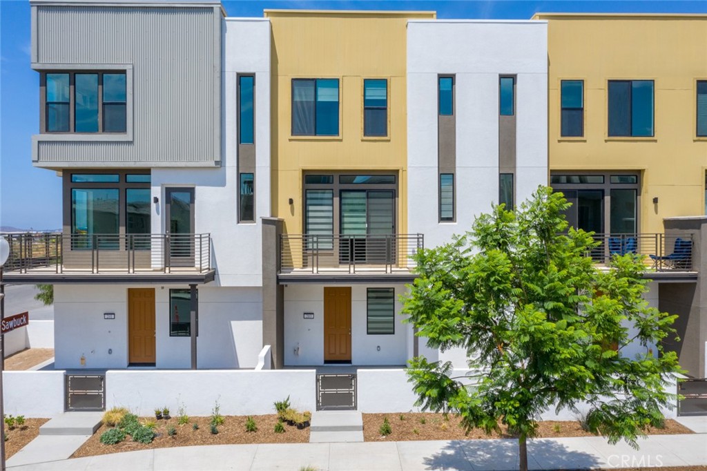 a front view of a house with plants