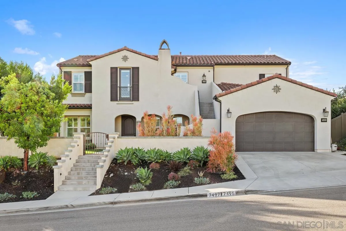7495 Paseo Cristal Carlsbad, CA 92009 - Photo 13 of 75 a front view of a house with a garden