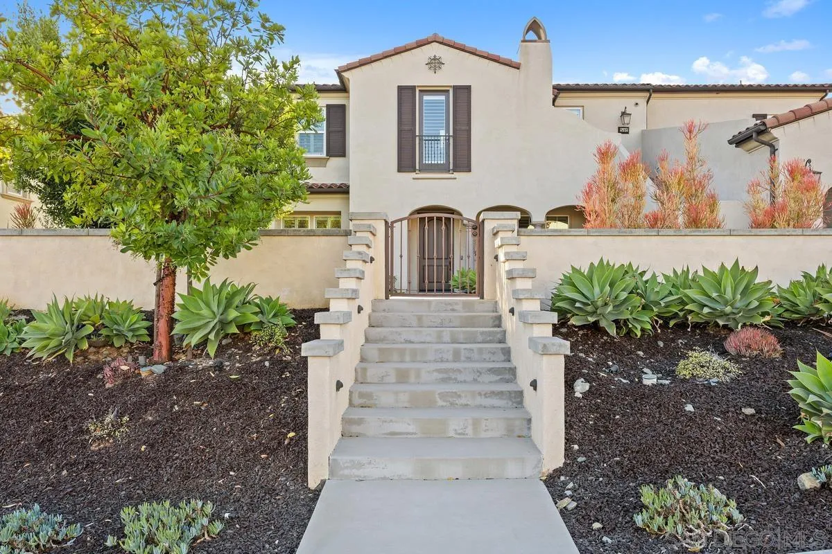 7495 Paseo Cristal Carlsbad, CA 92009 - Photo 14 of 75 a front view of a house with garden