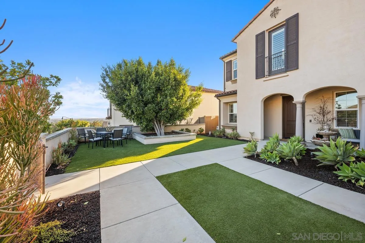 7495 Paseo Cristal Carlsbad, CA 92009 - Photo 16 of 75 a front view of a house with swimming pool and porch