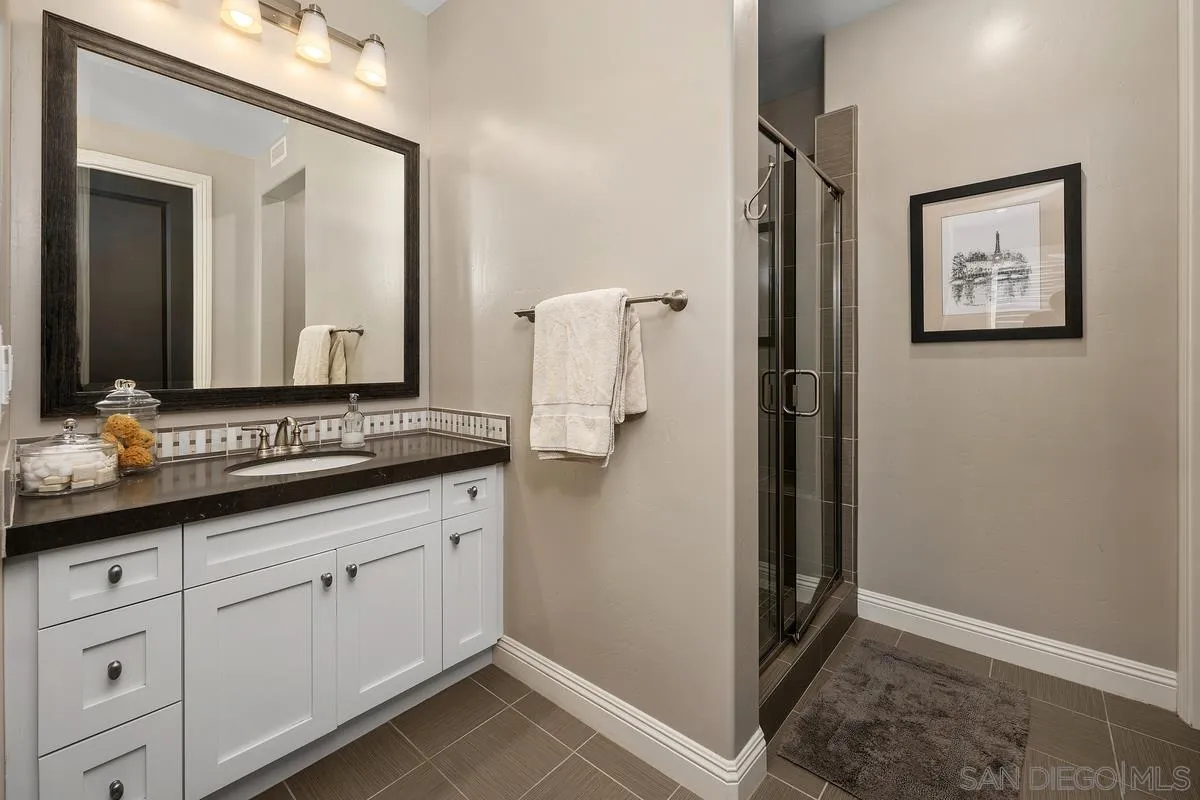 7495 Paseo Cristal Carlsbad, CA 92009 - Photo 34 of 75 a bathroom with a double vanity sink and mirror