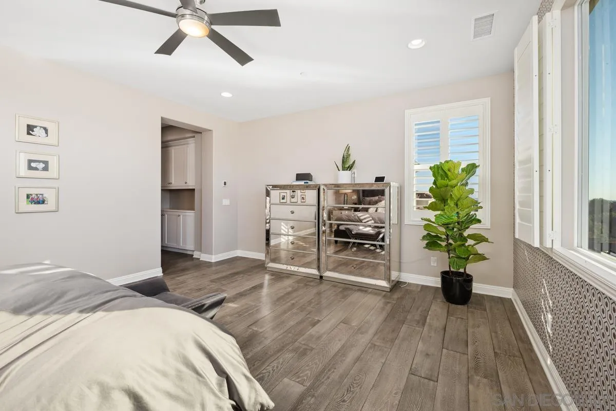 7495 Paseo Cristal Carlsbad, CA 92009 - Photo 37 of 75 a bedroom with furniture and a wooden floor