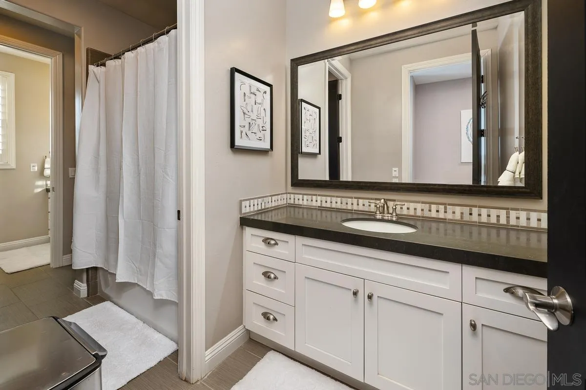 7495 Paseo Cristal Carlsbad, CA 92009 - Photo 47 of 75 a bathroom with a sink a mirror and a shower