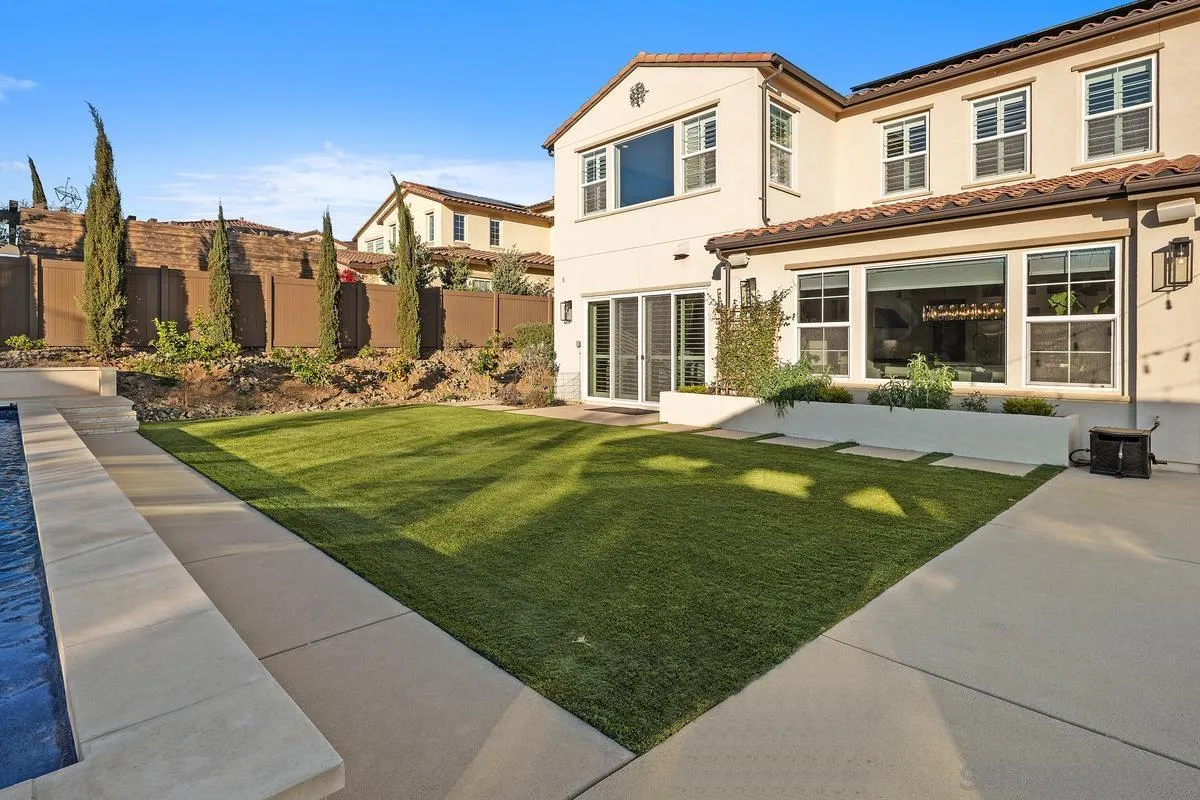 7495 Paseo Cristal Carlsbad, CA 92009 - Photo 56 of 75 a front view of a building with a garden