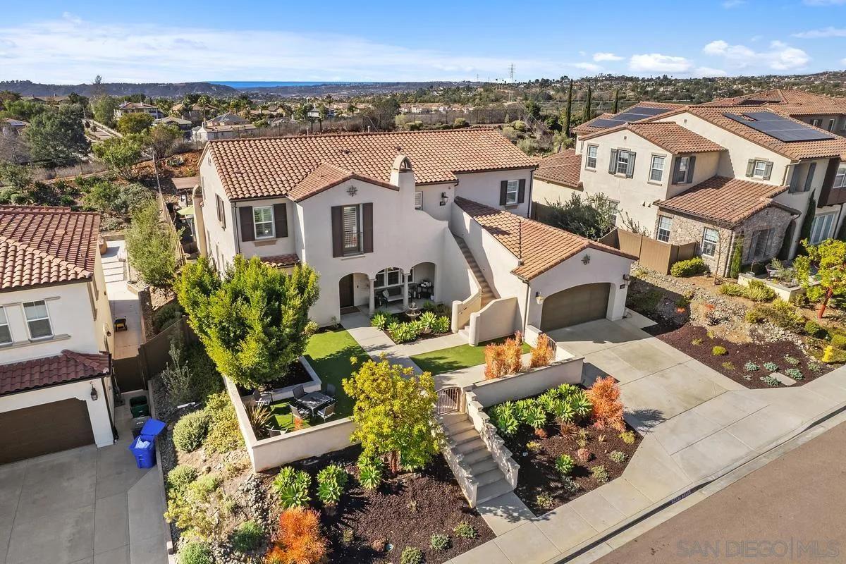 7495 Paseo Cristal Carlsbad, CA 92009 - Photo 68 of 75 an aerial view of a house with a garden and mountain view