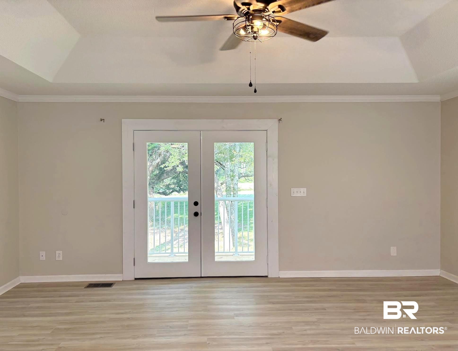 35650 Spring Road North Stapleton, AL 36578 - Photo 26 of 70 Doorway with a tray ceiling, french doors, wood finished floors, ornamental molding, and a ceiling fan